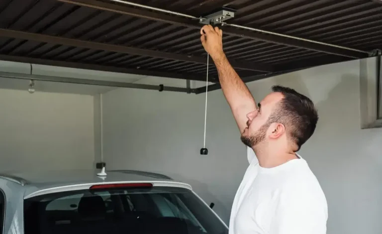 Man Performing Garage Door Maintenance