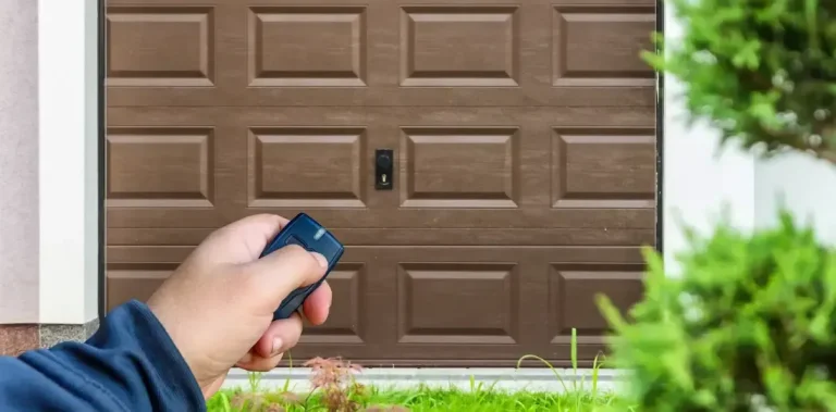 Person Using a Remote to Open a Sectional Garage Door